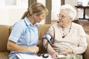 2194410-senior-woman-ihaving-blood-pressure-taken-by-health-visitor-at-home